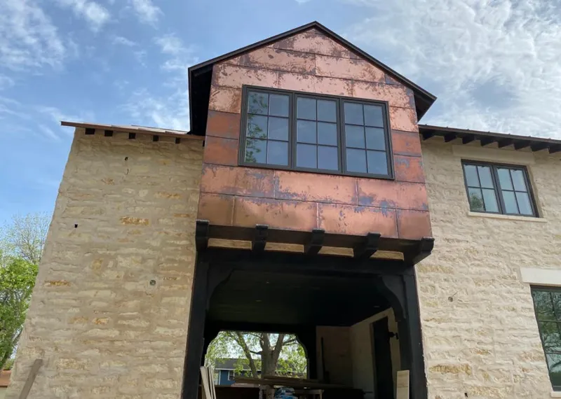 Copper metal panel facade on a stone building for Roof Repair in Wasilla