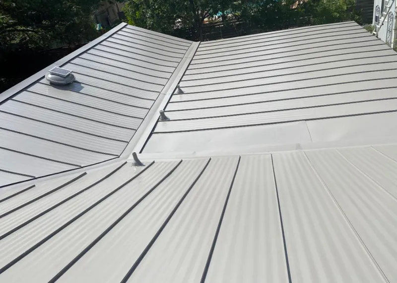 Solar attic fan installed on a metal roof for Roof Ventilation in Wasilla